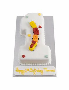 a white birthday cake with the number one on it's side and stars around it