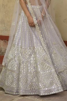 Lavender net cancan lehenga with all-over geometric motif water gold gota highlighted with sequins and crystals. Comes with embroidered padded blouse and dupatta.
Component: 3
Embroidered
Neckline: U Neck
Sleeve Length: Sleeveless
Fabric:  Net; Lining: Satin
Color: Purple
Kamar latkans - Aza Fashions Fitted Silver Lehenga For Eid, Silver Fitted Lehenga With Dupatta, Silver Choli With Sheer Dupatta, Floor-length Silver Lehenga For Festivals, Silver Floor-length Lehenga For Festivals, Fitted Silver Cutdana Set, Silver Fitted Sharara With Dupatta, Fitted Net Lehenga With Self Design, Fitted Silver Dupatta With Pallu