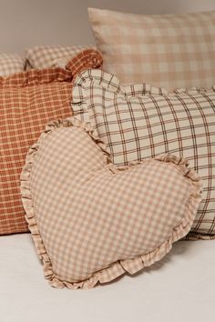 three pillows with ruffled edges on a bed