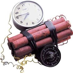 a clock sitting on top of a pile of dynamites next to a coiled rope