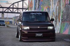 a van parked in front of a wall with graffiti on it's sides and the words, stevey motion written on its windshield