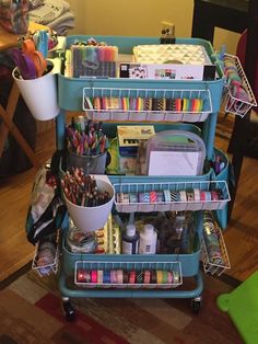 three tiered cart with lots of craft supplies on it