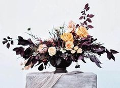 a vase filled with flowers sitting on top of a table