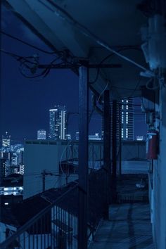 an empty balcony overlooking the city at night