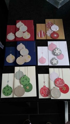 several different cards with ornaments hanging from them on a table in front of some shoes