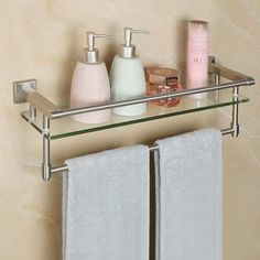 a bathroom shelf with towels and soaps on it