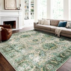 a living room filled with furniture and a large rug on top of a hard wood floor