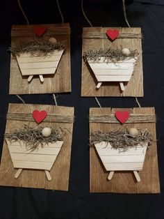 four pieces of wood with hearts attached to them