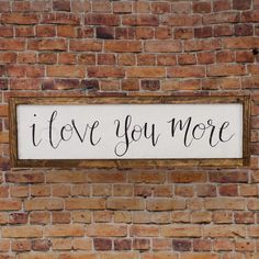 a sign that says i love you more on a brick wall