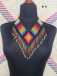 Mexican necklace, Huichol necklance, huchol choker, beaded choker. huichol art. This choker is a piece with a compound made by Huichol artisans, made entirely by hand, unique pieces, very colorful boho type, for any occasion. The Huichol artisans base all their works and their designs on visions they have during their sacred rituals proper to their ethnicity, The Huicholes inhabit the states of Nayarit, Jalisco, Zacatecas and Durango. Piece made by artisans nayaritas. Sent anywhere in the world Colorful Adjustable Traditional Necklaces, Traditional Multicolor Handwoven Choker, Colorful Traditional Beaded Necklaces For Festivals, Traditional Tiny Beads Choker For Festivals, Traditional Festival Choker With Tiny Beads, Traditional Multicolor Tiny Beads Choker, Traditional Multicolor Beaded Choker, Multicolor Handwoven Beaded Choker Necklace, Multicolor Handwoven Festival Choker