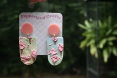 These earrings feature a unique design pulled from the dreamscape of the sculptor: true cotton candy clouds! You don't have to be a child to enjoy the youthful joy of cotton candy, and these quirky statement pieces match an array of outfits with their spectrums of color. As always, these are especially wonderful if you're looking for a touch of whimsy in your daily life, or even just a way to showcase your appreciation for color, joy, and treats! Each pair is hand-sculpted from polymer clay, a material so lightweight you often forget you're wearing any earrings at all. Every pair is totally hand sculpted. This means that your pair is like no other in the world! Guaranteed to be 100% one-of-a-kind, and 100% yours. Sport these ultra-lightweight and naturally water-resistant dangles anywhere Handmade Pastel Earrings For Gift, Pastel Handmade Earrings For Gifts, Artistic Handmade Pink Earrings, Artistic Pink Dangle Earrings, Trendy Handmade Pastel Earrings, Artistic Pink Earrings Perfect For Gifts, Artsy Pink Earrings For Gifts, Pink Artsy Polymer Clay Earrings, Artsy Pink Polymer Clay Earrings