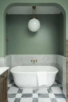 a white bath tub sitting inside of a bathroom