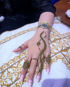 a woman's hand with hennap on it sitting on top of a table