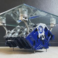 a blue engine is sitting under a glass table