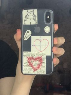 someone is holding up their phone case with drawings on it and hearts drawn on the back