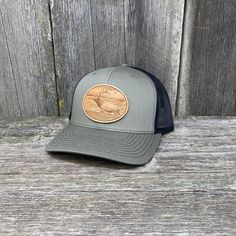 Description Wear it to dinner or in the mountains. This River Elk Patch hat is captured in a great Oval design and is one of our best sellers. This Elk Crossing the river design was cut from top-grain leather here in Idaho and the design shows who you are and what you're about Key Features Size: One Size Fits Most Fit: Adjustable Snapback Richardson 112 mesh back trucker cap with top-grain leather Sasquatch design Cotton-Poly/Nylon-Mesh material with pre-curved visor Nine colors to choose from: Western Style Outdoor Snapback Hat With Short Brim, Western Style Snapback Hat With Short Brim For Outdoor, Western Hats With Leather Patch For Outdoor, Western Outdoor Hat With Leather Patch, Western Style Hat With Leather Patch For Outdoor, Adjustable Snapback Hat For Outdoor Work, Adjustable Short Brim Hat With Leather Patch, Outdoor Hats With Leather Patch And Curved Brim, Outdoor Hats With Curved Brim And Leather Patch