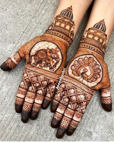 two hands with henna designs on them