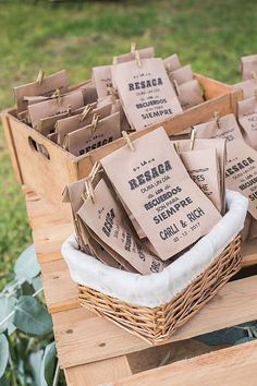 some brown paper bags sitting on top of a wooden table with green plants in the background