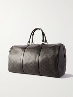 CELINE HOMME's 'Sac De Voyage' weekend bag is the perfect travel companion. It's been crafted in Italy from hardwearing coated-canvas and printed with the house's unmistakable 'Triomphe' monogram. Finishing touches include supple leather trims, gold-tone accents and a secure padlock fastening. Luxury Monogram Canvas Duffle Bag, High-end Travel Bag With Leather Trim, High-end Travel Shoulder Bag With Leather Trim, High-end Shoulder Bag With Leather Trim For Travel, High-end Travel Bag With Leather Handles, Luxury Monogram Canvas Travel Bag For Daily Use, Luxury Travel Bag In Monogram Canvas, High-end Rectangular Bag With Leather Trim, Business Bags In Signature Coated Canvas