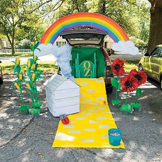 a car parked in front of a tent with decorations on the ground next to it