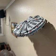 a star wars model is hanging on the wall