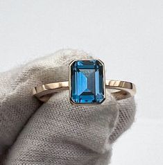 Solid 14k rose gold Ring with London Blue topaz  Topaz 2.1 carats (8x6mm) 14k gold band 2x2mm (square wire) Ring weight approximately ~ 3.5g This natural topaz Ring in solid 14k gold is absolutely beautiful.  Handcrafted Ring. Ring will be packed in a beautiful gift box and bag, ready for giving!💗 PLEASE NOTE- shipping time does not include making time. It generally takes  3-5 days for the jewelry to be made. *PLEASE NOTE-  We offer standard free shipping worldwide (You will receive your order within 7 - 21 business days) And we also offer express shipping with FedEX courier (for additional cost, but You will receive your order within 2 - 5 business days) Please check out my etsy shop for more great item and deal: www.etsy.com/shop/pearlsboxshop  Please follow me on my Instagram account Large Diamond Rings, Topas Ring, 1 Carat Engagement Rings, Wire Ring, 14k Rose Gold Ring, Handcrafted Rings, London Blue Topaz, Blue Topaz Ring, London Blue