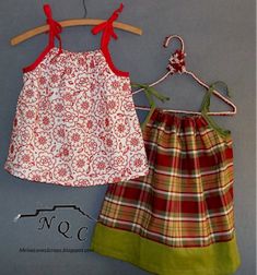 two children's clothing hanging on a clothesline, one is red and the other is green