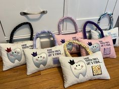 four pillows with toothbrushes on them sitting in front of a door