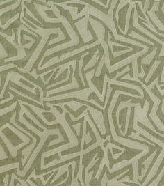 a green and white rug with an abstract design on it