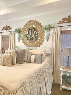 a bed room with a neatly made bed next to two windows and a ceiling fan