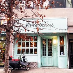 a scooter is parked in front of a restaurant with lights on the windows