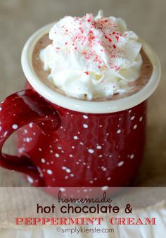 a red mug filled with whipped cream and candy canes