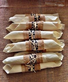 four pieces of cloth wrapped in brown and white material with leopard print on the ends