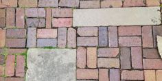 the sidewalk is made out of bricks and grass