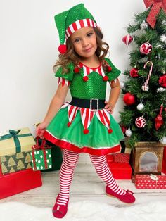 Your sweet elf will sparkle with joy in our sequin tutu dress. Dressing your merry munchkin in her holiday best has never been quite as fun as this. It's the most fashionable time of the year! Keeps its cuteness wash after wash Buttery-soft fabric for all-day comfort Perfect her Holiday party, formal event, pageant, pretend play, or pictures wardrobe Puff-sleeve elf tutu dress with pom-pom applique collar, sequin mesh bodice, velvet belt, striped fabric with pom-pom tassels, and a gathered tulle Elf Outfit Kids, Elf Costume Girl, Christmas Pageant Wear, Christmas Outfit For Kids, Kids Christmas Dress, Velvet Belt, Toddler Flower Girls, Set Dressing