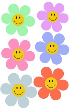 four different colored flowers with smiley faces on them