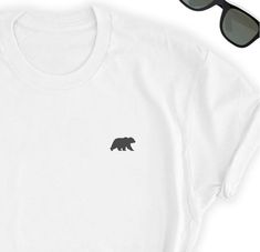 Love Bears? Take this beautiful simple Bear design to your side everywhere. Friends will love it!This t-shirt feels soft and lightweight, with the right amount of stretch. It's comfortable and flattering for both men and women. • 100% cotton (heather colors contain polyester)• Fabric weight: 5 oz��• Shoulder-to-shoulder taping• Side-seamedTime for Delivery:• Processing & production time is 1-6 business days (usually 2-3 days).• U.S. Shipping time: 3-5 business days. • International shipping ti Bear Icon, Long Lashes Mascara, Icon Shirt, Pug Gifts, Elephant Shirt, Elephant Lover, Love Bear, Bear Shirt, Cat Tee