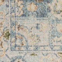 an area rug with many different colors and patterns on it, including blue, beige, green