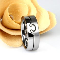 two wedding rings sitting next to each other on top of some pancakes in front of a white background