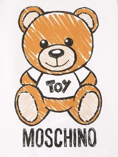 a brown teddy bear sitting on top of a white t - shirt that says moschino