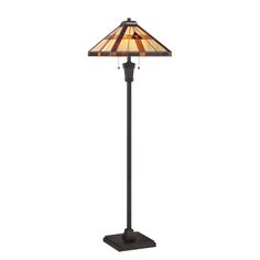 a floor lamp with a stained glass shade on it's base and an iron stand