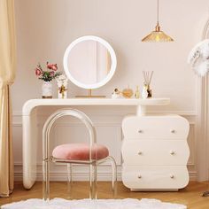 a white vanity with a mirror and stool