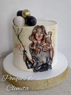 a decorated cake with a woman holding a wine glass and two balloons on top of it