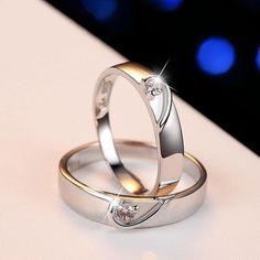 two wedding rings sitting on top of each other