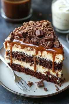 a piece of cake on a white plate with chocolate and caramel drizzle