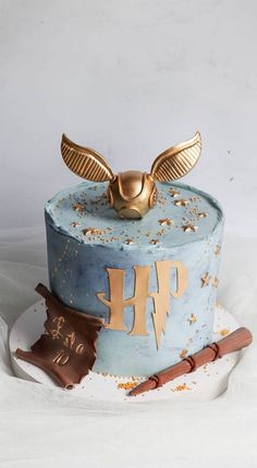 a blue cake with gold decoration on top