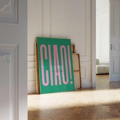 there is a sign that says ciao in pink on the green board next to it