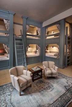 a living room filled with furniture and bunk beds next to each other on top of a rug