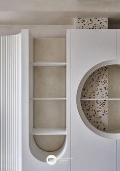 a white book shelf sitting next to a radiator in a room with no one inside