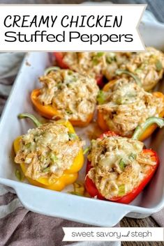 several stuffed peppers in a white casserole dish with text overlay that reads creamy chicken stuffed peppers